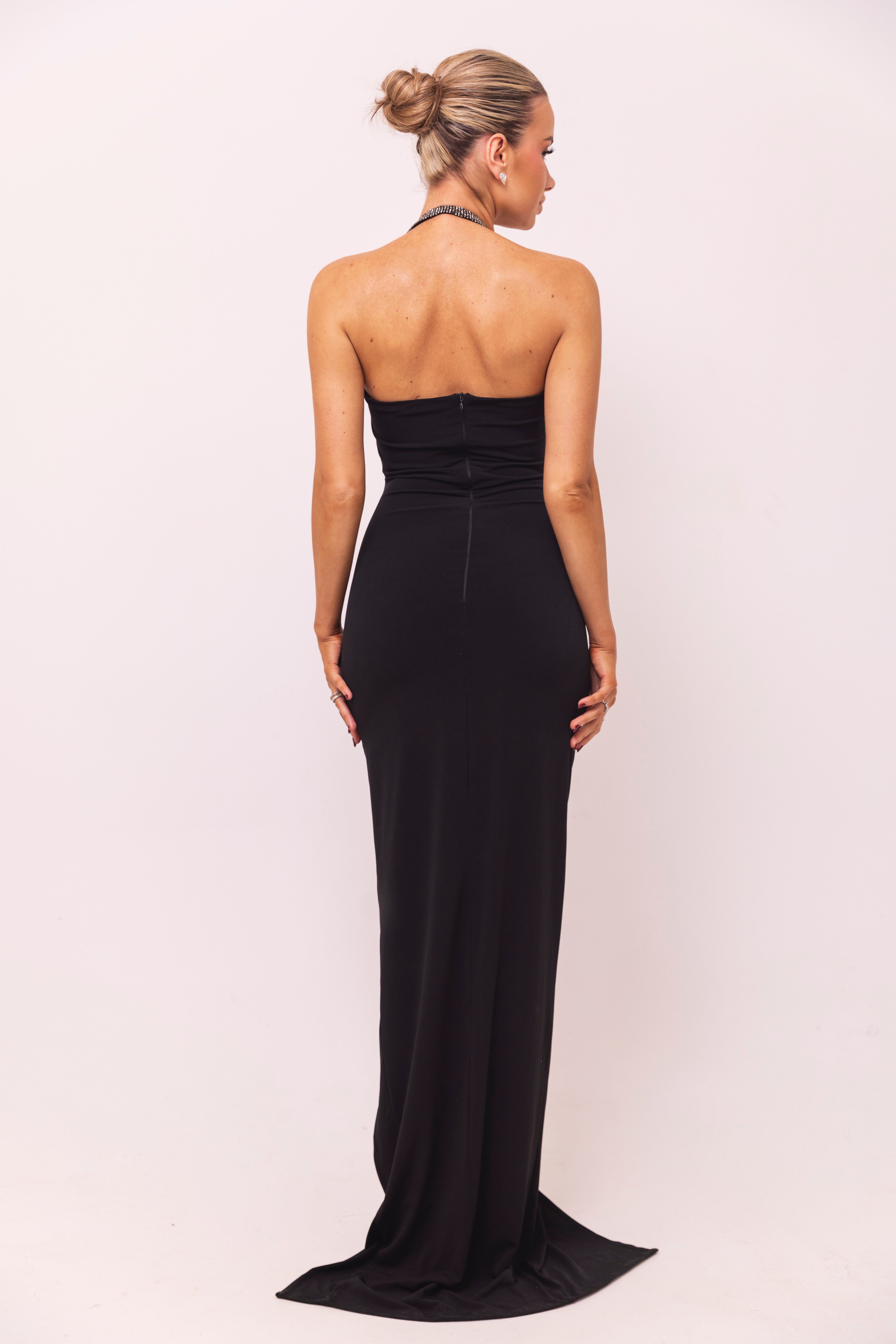 Glamorous black gown with a rhinestone halter strap and dazzling bust detailing.