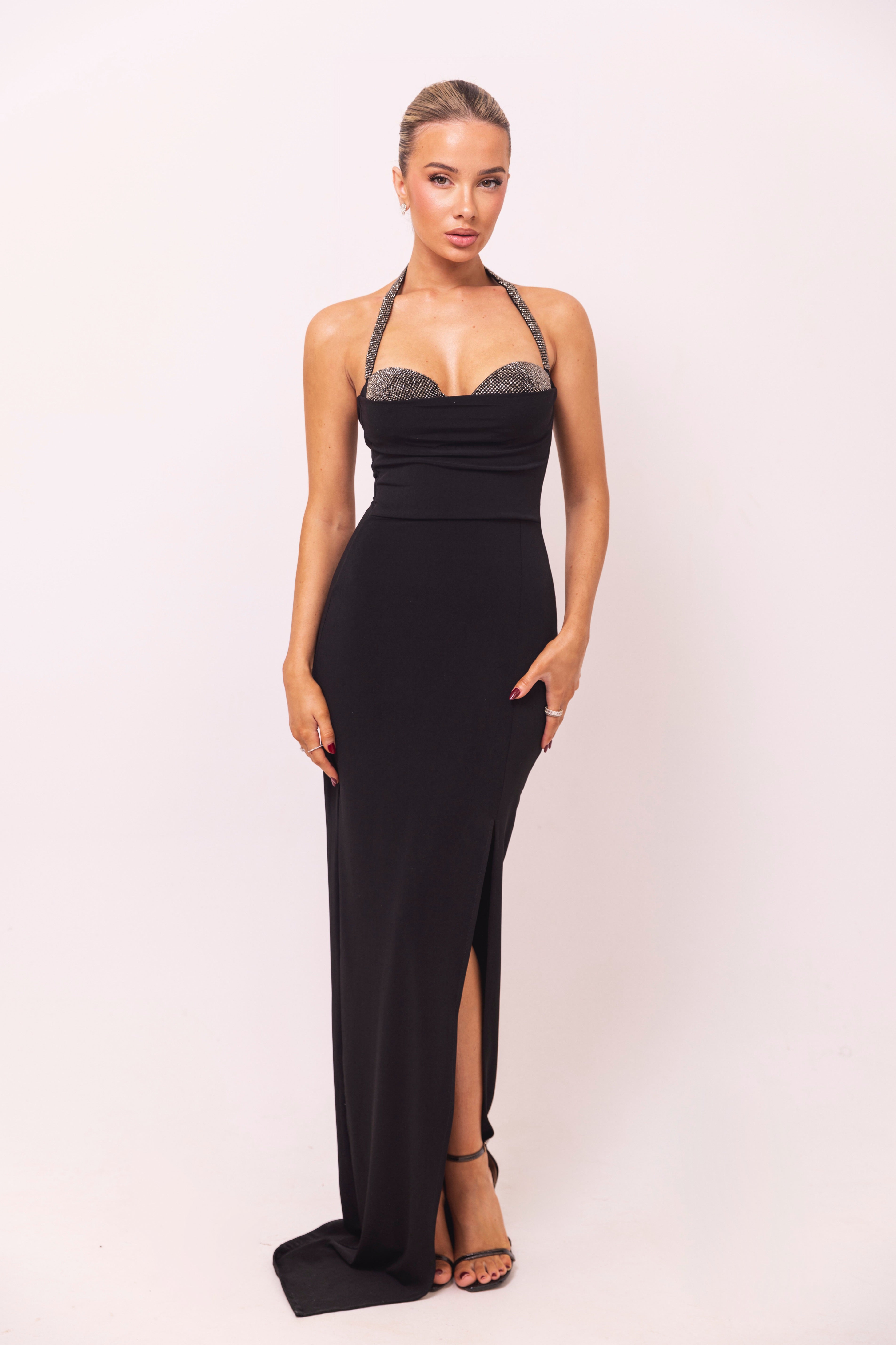 Elegant black dress with a rhinestone-embellished strap and a sparkling beaded bust detail.