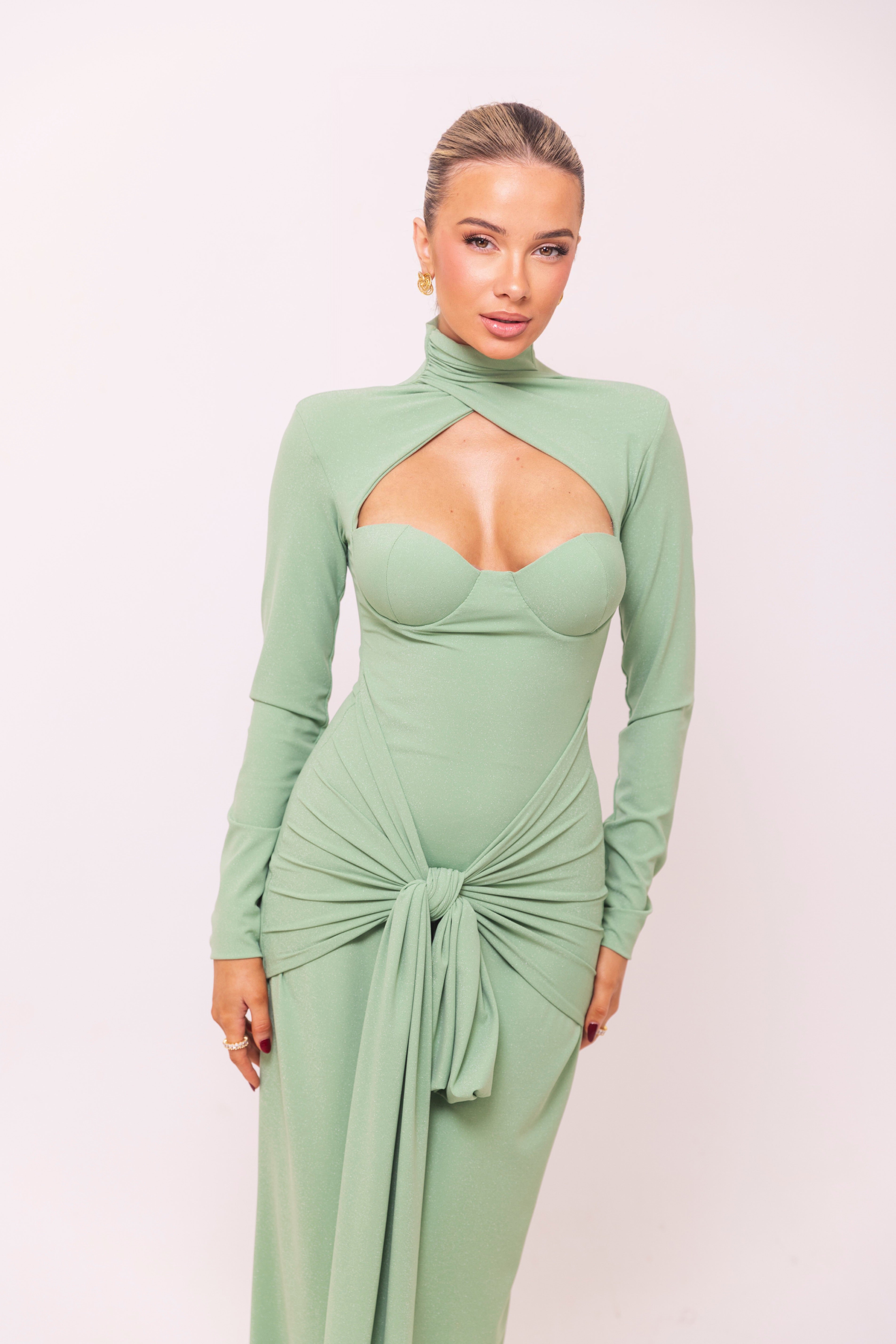 Light green gown with a structured bustier top and long sleeves, perfect for formal occasions.