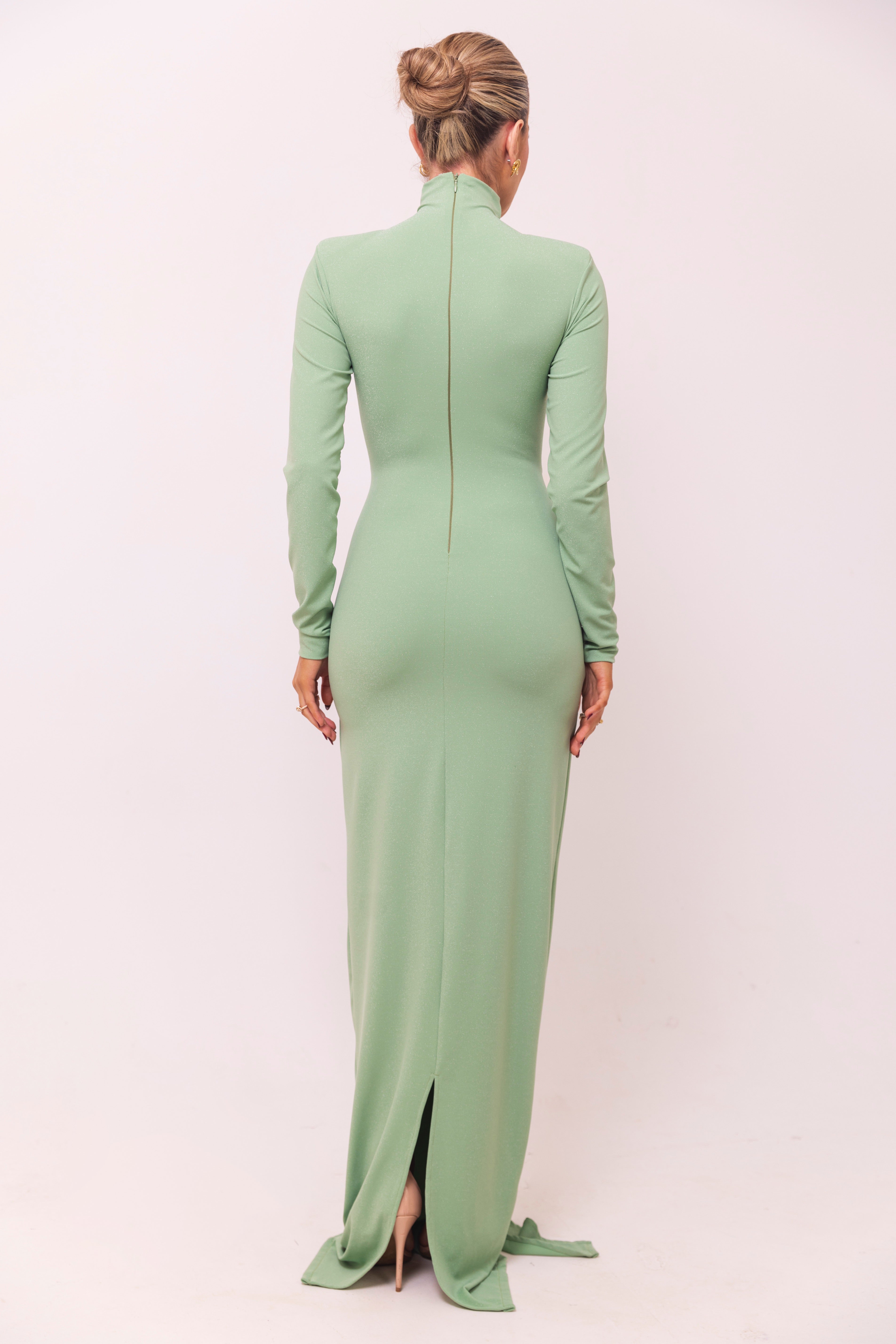 Mint green dress with a structured bust, long sleeves, and a knotted waist detail.