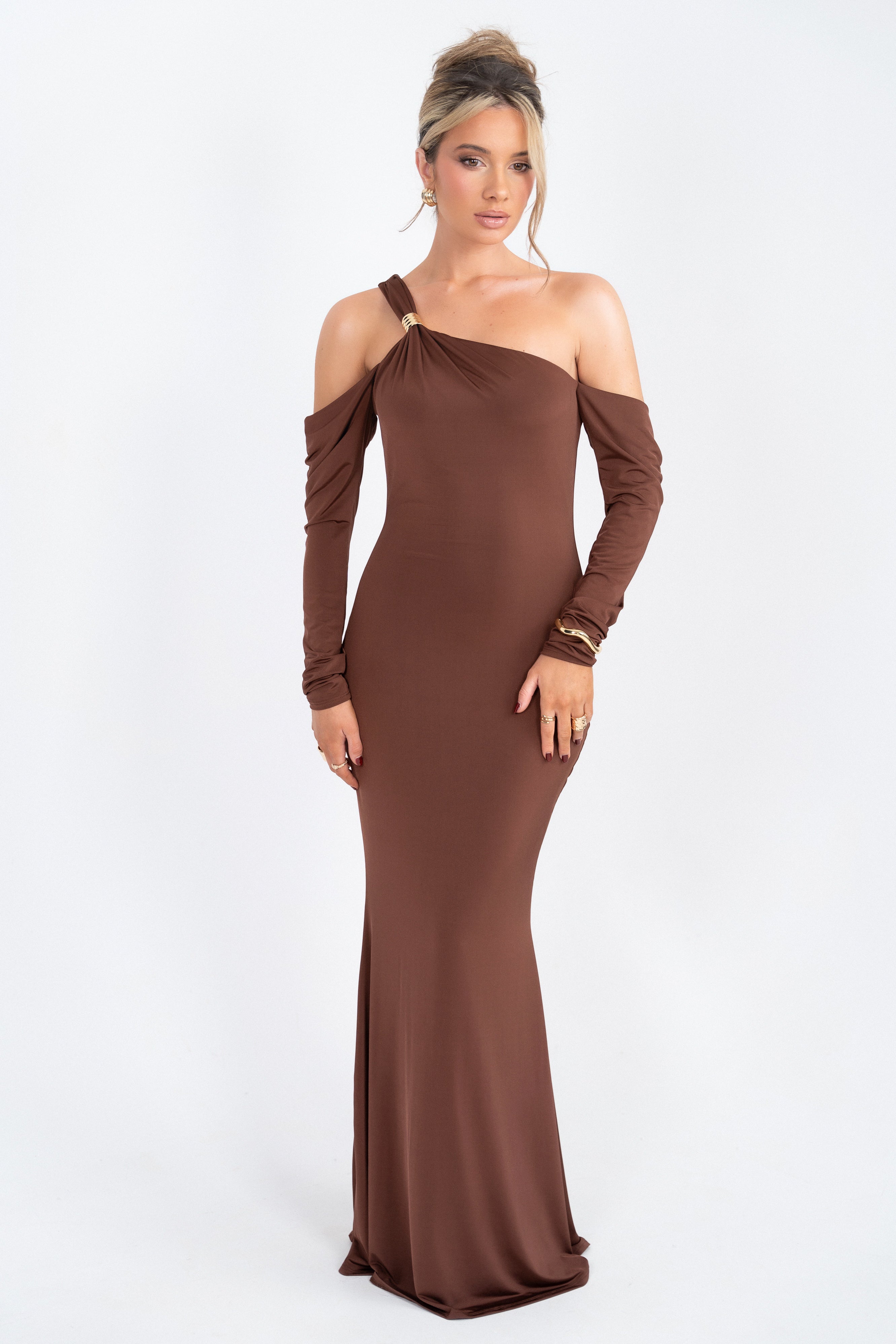 Chic brown dress with a deep v-neckline and a decorative rhinestone clasp at the waist.