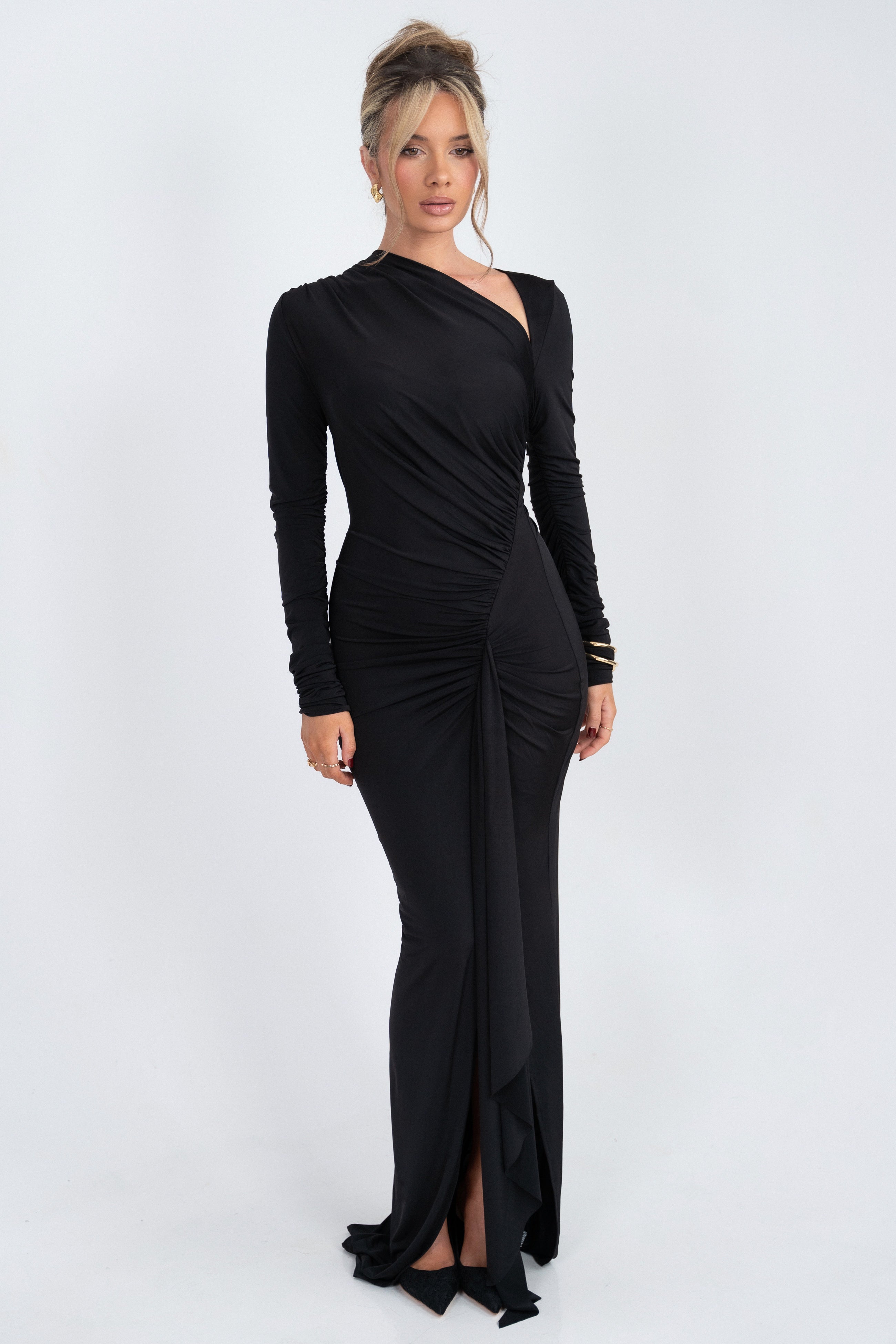 Black dress with an asymmetrical neckline and ruched detailing for a sleek look