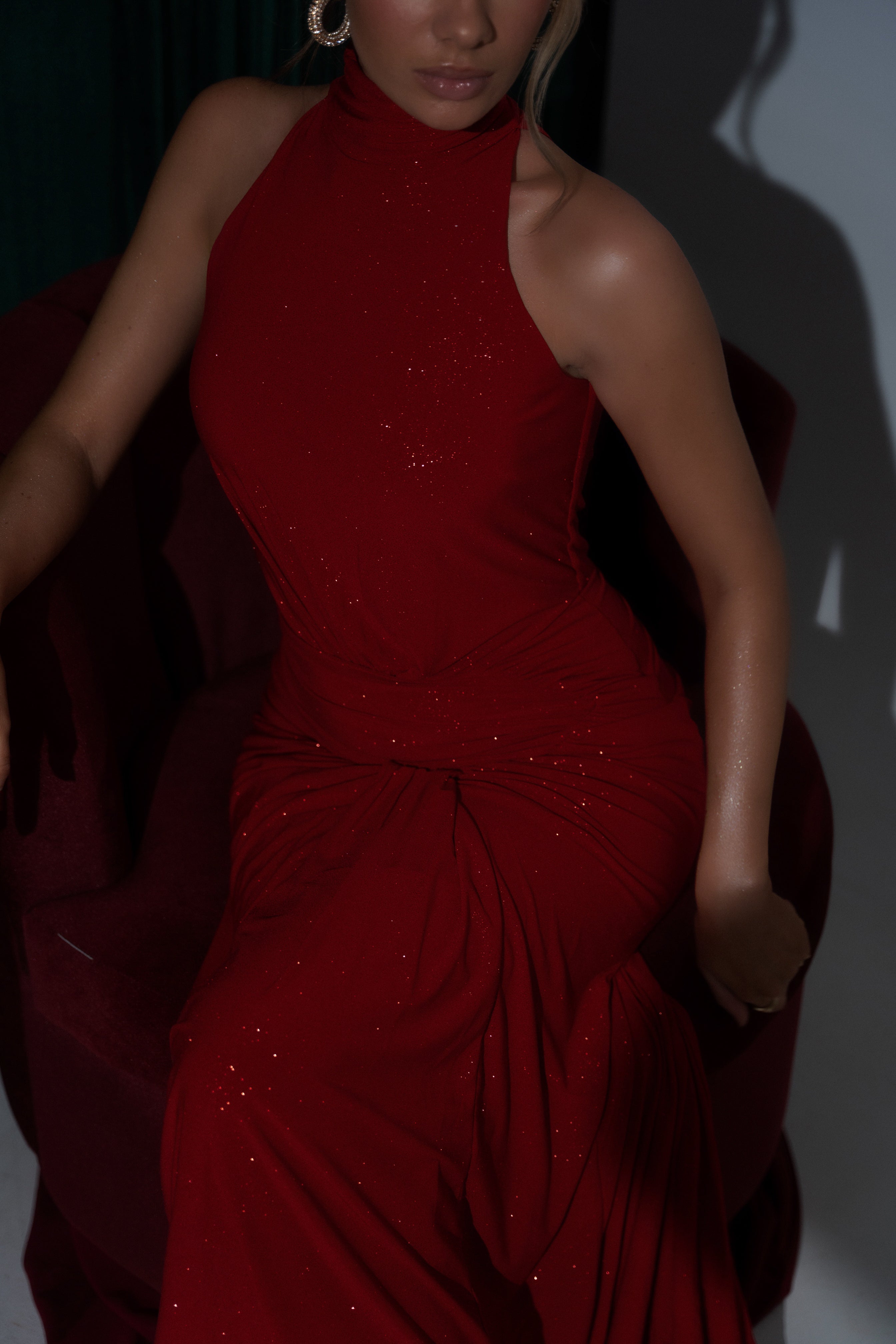 Sophisticated red dress with shimmering details and a flattering ruched design.