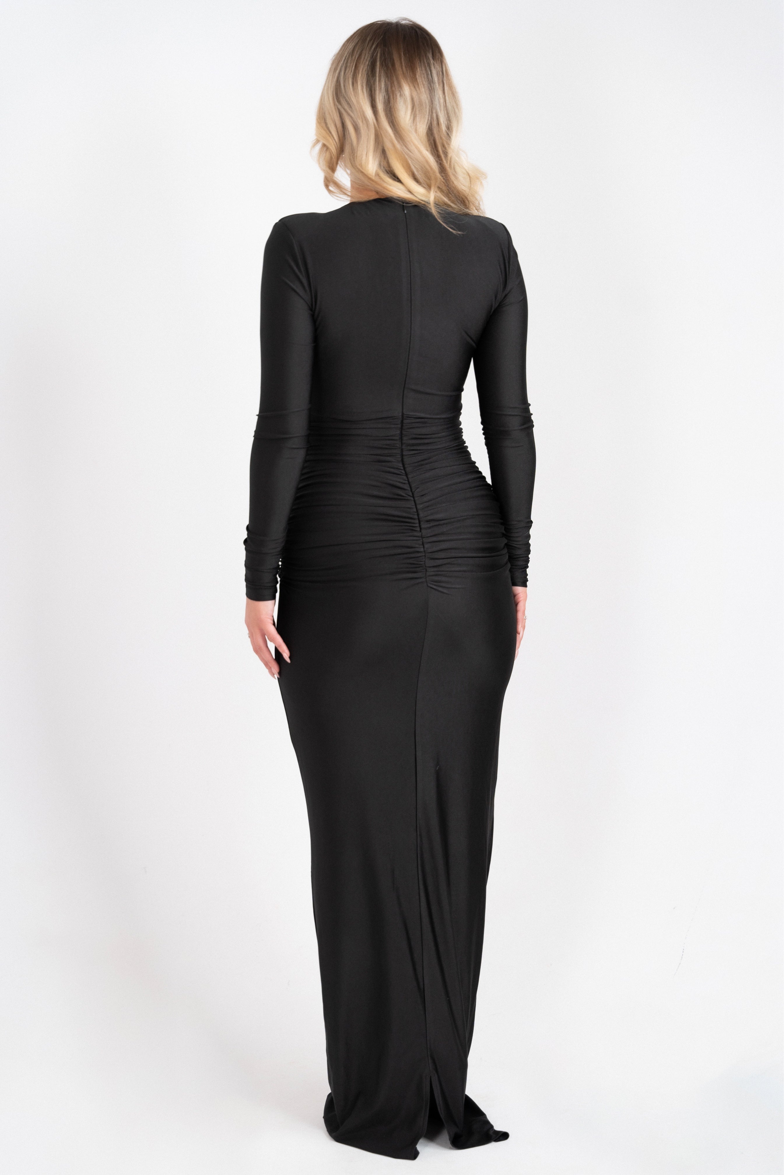 Black evening dress with a refined design, long sleeves, and a dazzling jeweled accent